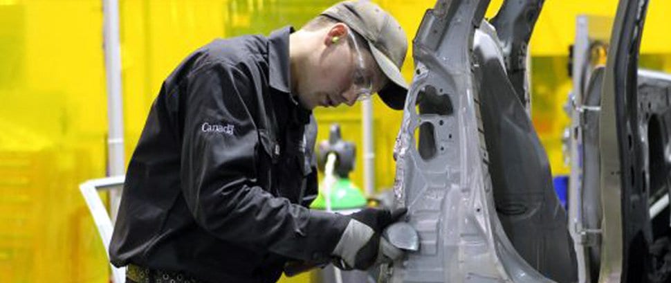 Technician wear safety goggles and gloves working on a machine part